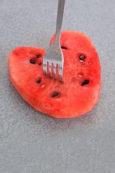 Watermelon fruit prong dip on rock