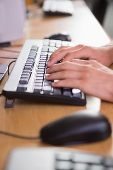 Student using computer in classroom at the university