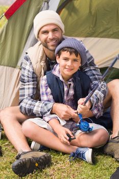 Father and son in their tent on a sunny day
