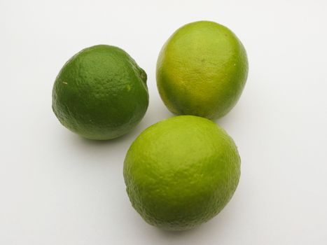 Three lime citrus fruits over white background