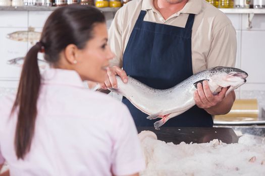 Man selling a pink salmon