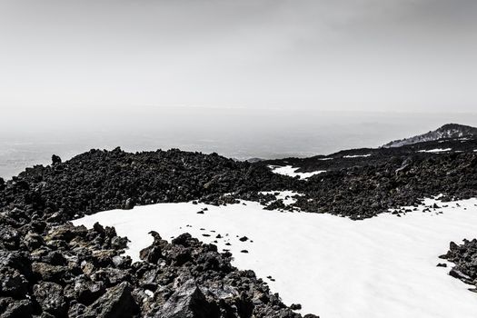 Etna mountain landscape, volcanic rock and snow, Sicily, Italy