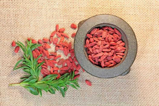 Dry goji berries in a stone mortar.