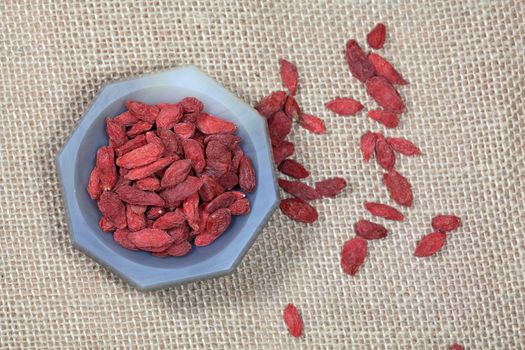 Dry goji berries in a stone mortar.