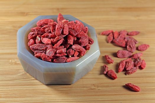 Dry goji berries in a stone mortar.