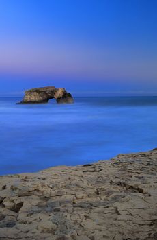 Natural Bridges rock in the Beach of Santa Cruz, California, USA. With ocean wave in the foreground.