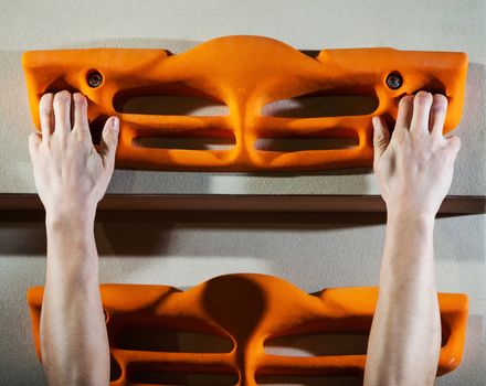 Cropped view of rock climber performing three-finger pull-ups