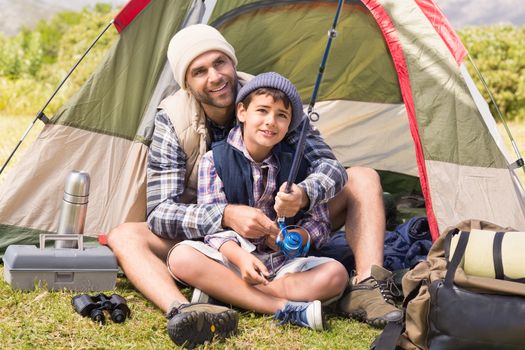 Father and son in their tent on a sunny day