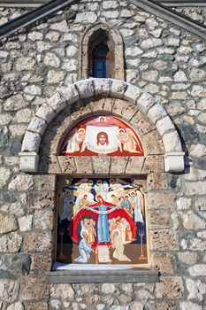 Religious painting on facade of the Templar Church in Bran, Romania