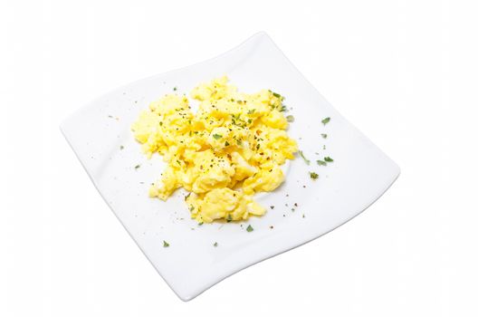 Breakfast with scrambled eggs. Plate of scrambled eggs on a plate against bright white background.