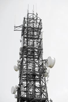 communications tower against a white sky in ireland