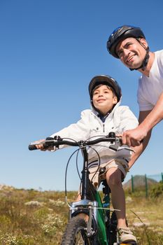 Father and son on a bike ride on a sunny day