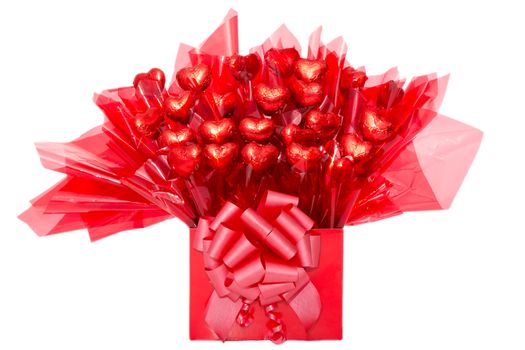 Colorful red gift of heart-shaped chocolate flowers in decorative cellophane tied with a bow for a loved one or sweetheart on Valentines Day, anniversary or Mothers Day, isolated on white