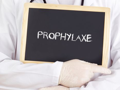 Doctor shows information on blackboard: prophylaxis in german