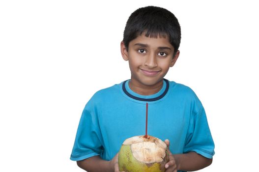 Handsome Indian kid cooling off with fresh coconut