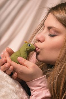 girl kisses frog for it to become a prince