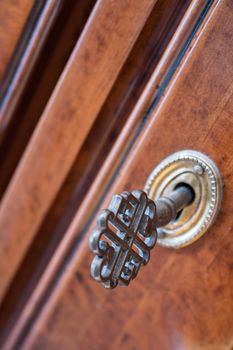 closeup of old iron key in the lock