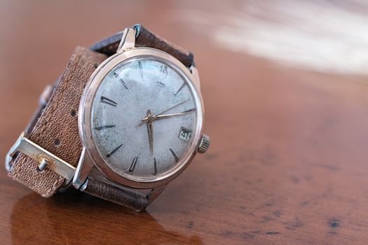 old wrist watch on a wooden base