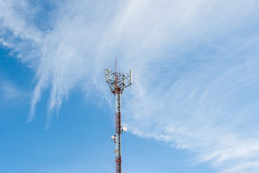 Telecommunications pole with nice cloud in sky