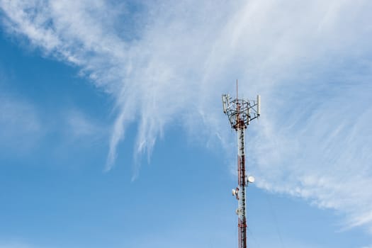 Telecommunications pole with nice cloud in sky