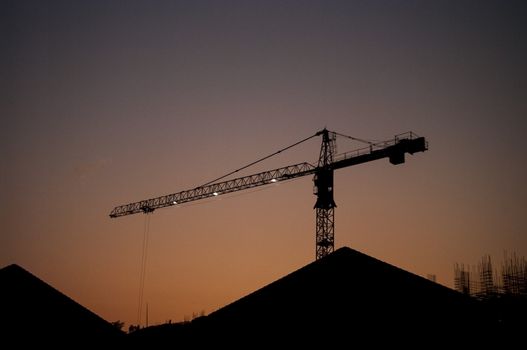 Silhouette crane with sunset sky, Construction site