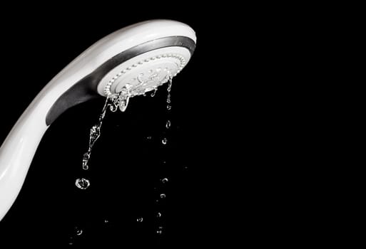 Modern shower head  with running water  isolated on black background