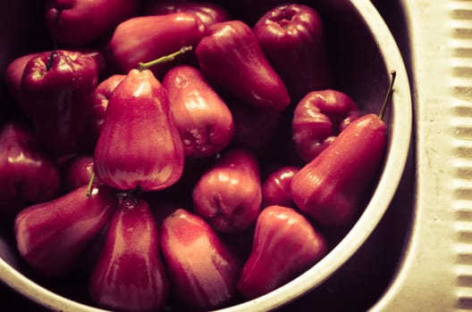 Rose apple in metal bowl for water washing  in vintage color style