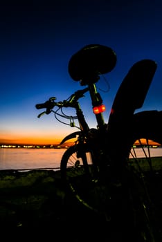 Mountain bike paking beside sea with twilight sky