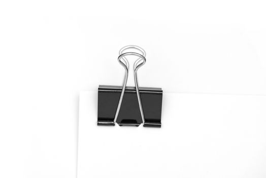 Black clerical clip for paper on white background