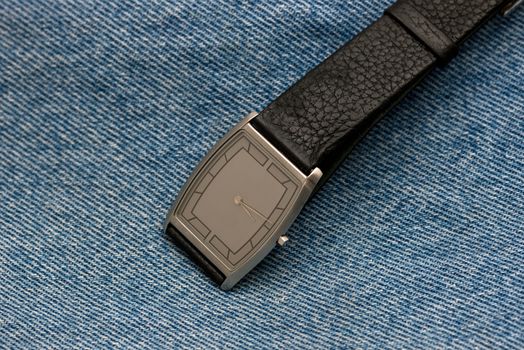 wrist watch on a background made from close up of texture in jeans