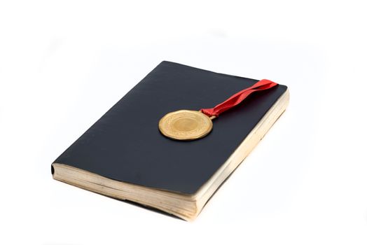 A book and medal isolated on white background concept of graduation