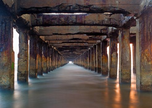 Broken Pier during sunrise on a winter day