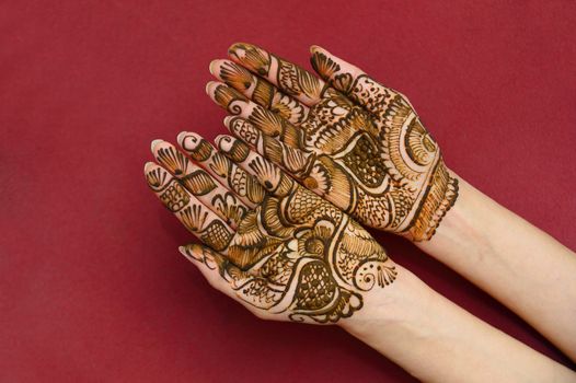 beautifully decorated indian hands with mehandi typically done for weddings