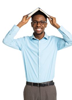 Happy african american college student with books in his hands standing on white background