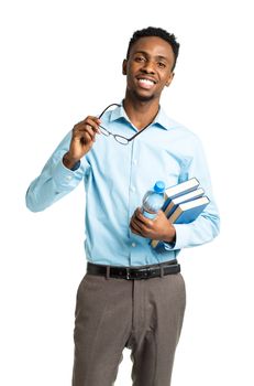 Happy african american college student with books in his hands standing on white background