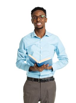 Happy african american college student with books in his hands standing on white background