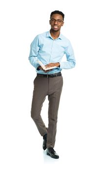 Happy african american college student with books in his hands standing on white background