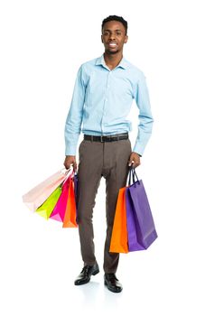 Happy african american man holding shopping bags on white background. Holidays concept
