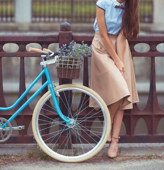 Young beautiful, elegantly dressed woman with bicycle. Beauty, fashion and lifestyle