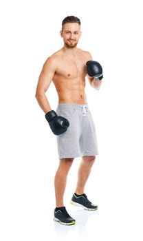 Athletic attractive man wearing boxing gloves on the white background