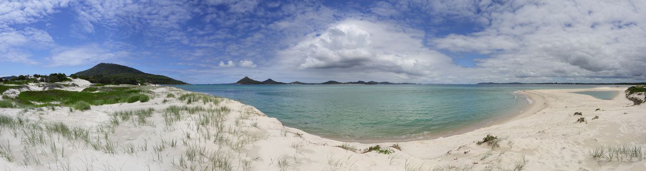 Scenic panoramic views of the sand dunes and lake at Winda Woppa, Hawks Nest, including Jimmy's Beach, Port Stephens.    Yacaaba Head, Mt Tomaree, Stephens Peak and the coastal towns of Shoal Bay and Nelson Bay on the horizon.