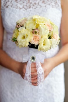 Bride is holding a bouquet in hand.