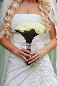 Bride is holding a bouquet in hand.