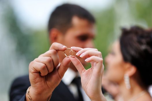 bride and groom holding hands in a ring.