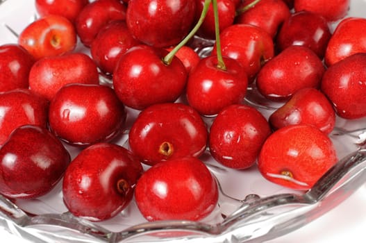 Group of red cherries in a vase with water, close-up