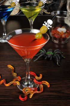 Cocktail with olives on a cocktail stick in honor of Halloween