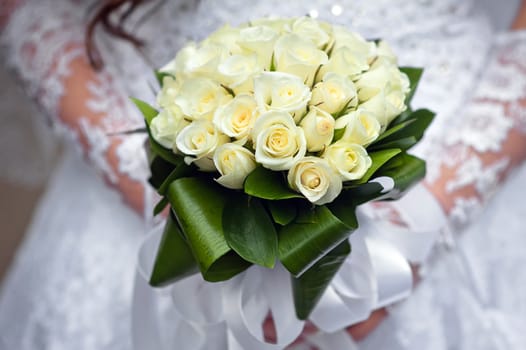 wedding bouquet at bride's hands.