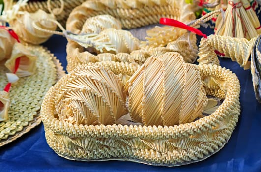 Woven from beautiful straw boxes and other Souvenirs placed on the table, covered with blue silk. This products for sale at the fair.