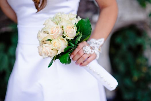 wedding bouquet at bride's hands.