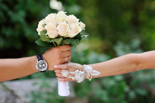 groom gives the bride a bouquet of roses.